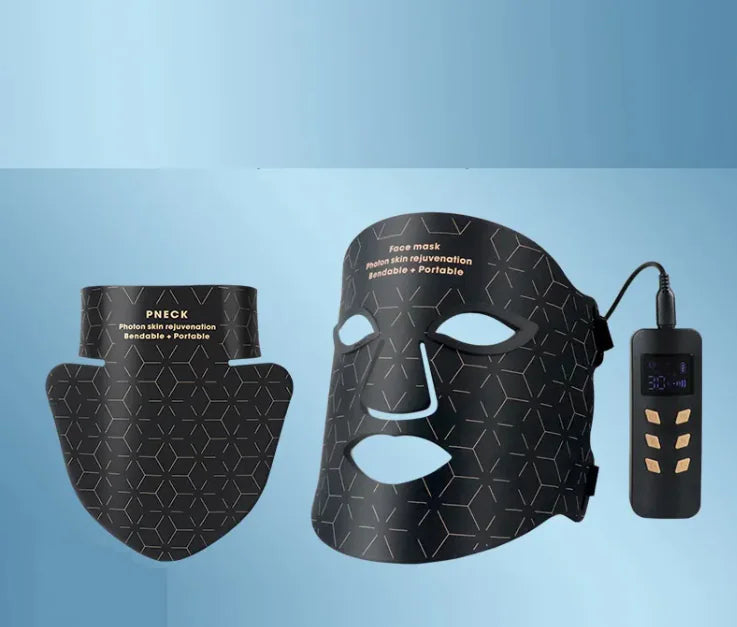 Black facial mask with attachments and control device on a blue background